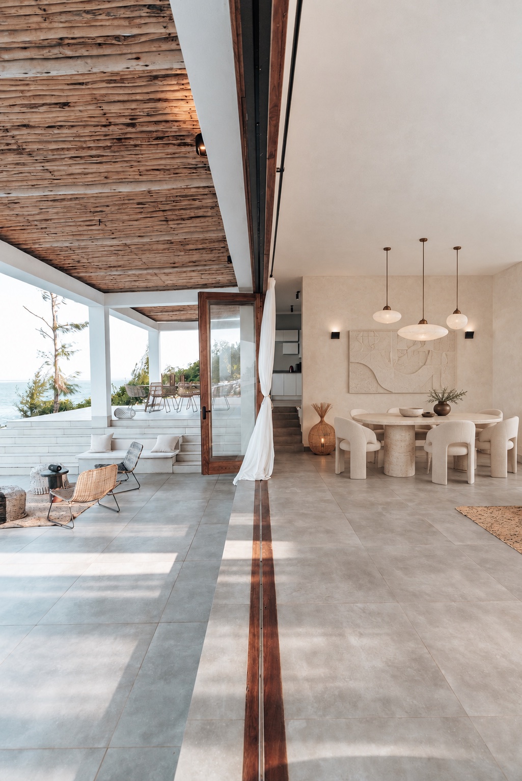 Sunlit living space with natural textures and sculptural furniture